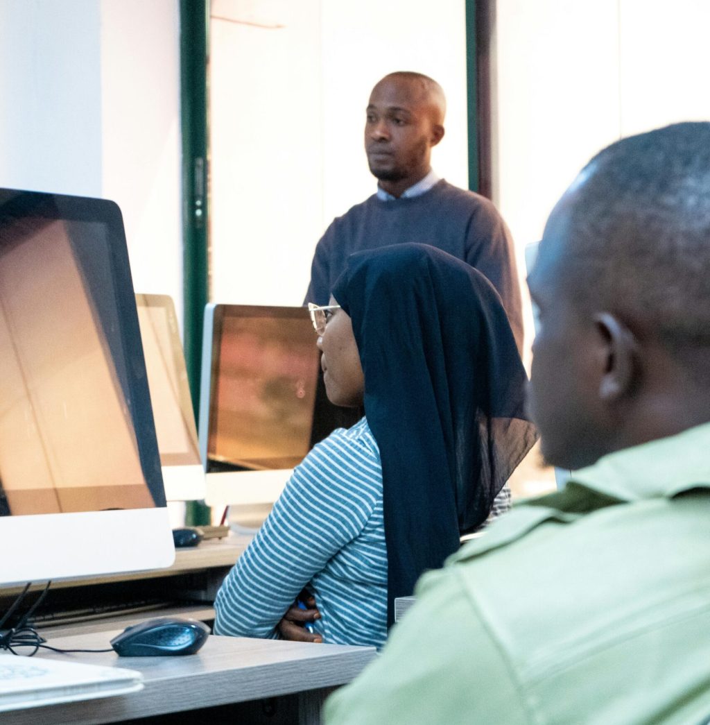 Students engaging in coding at a modern computer lab with a focus on ICT skills.